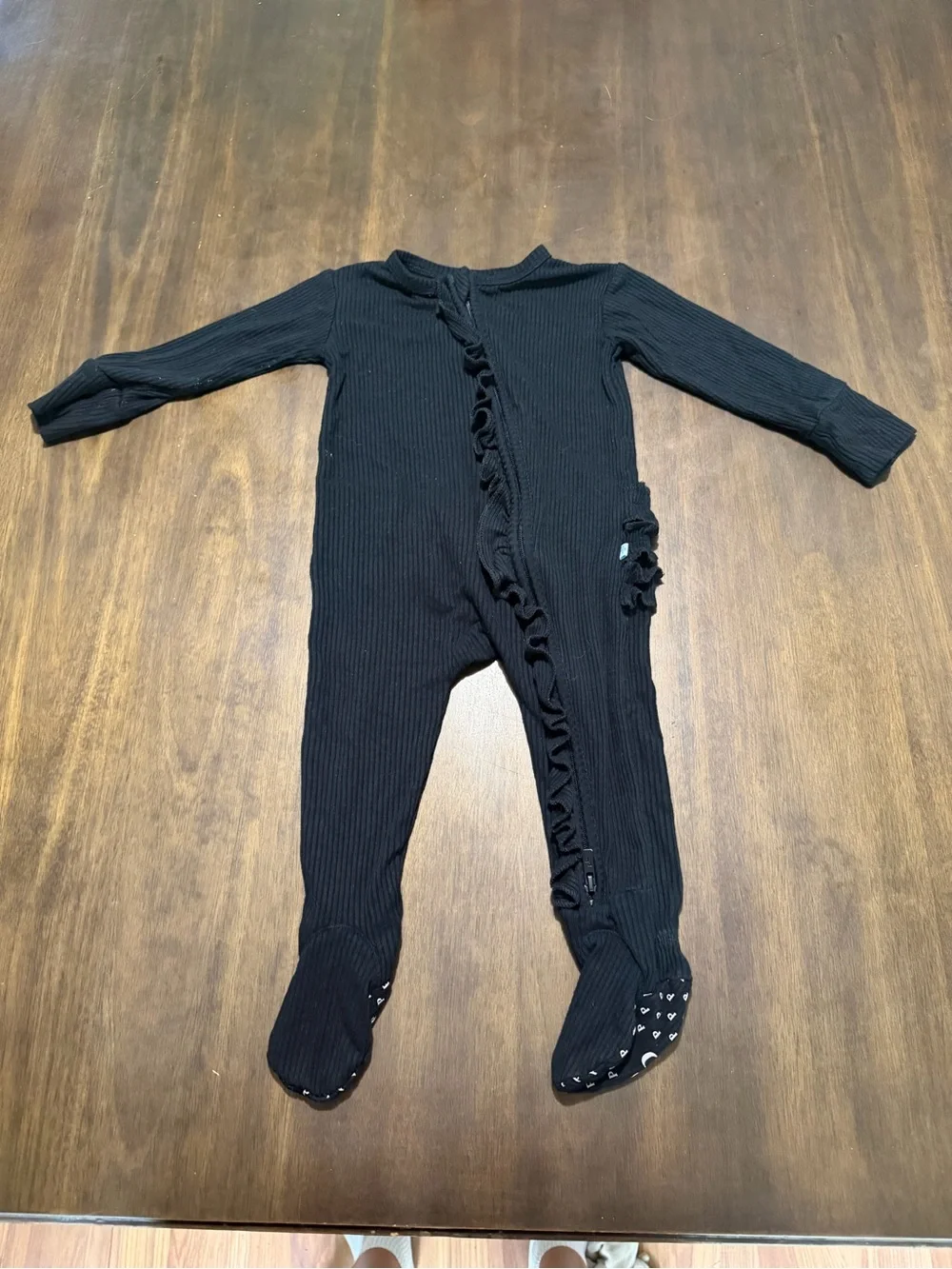 Posh Peanut Black Ribbed Ruffle Footed One-Piece